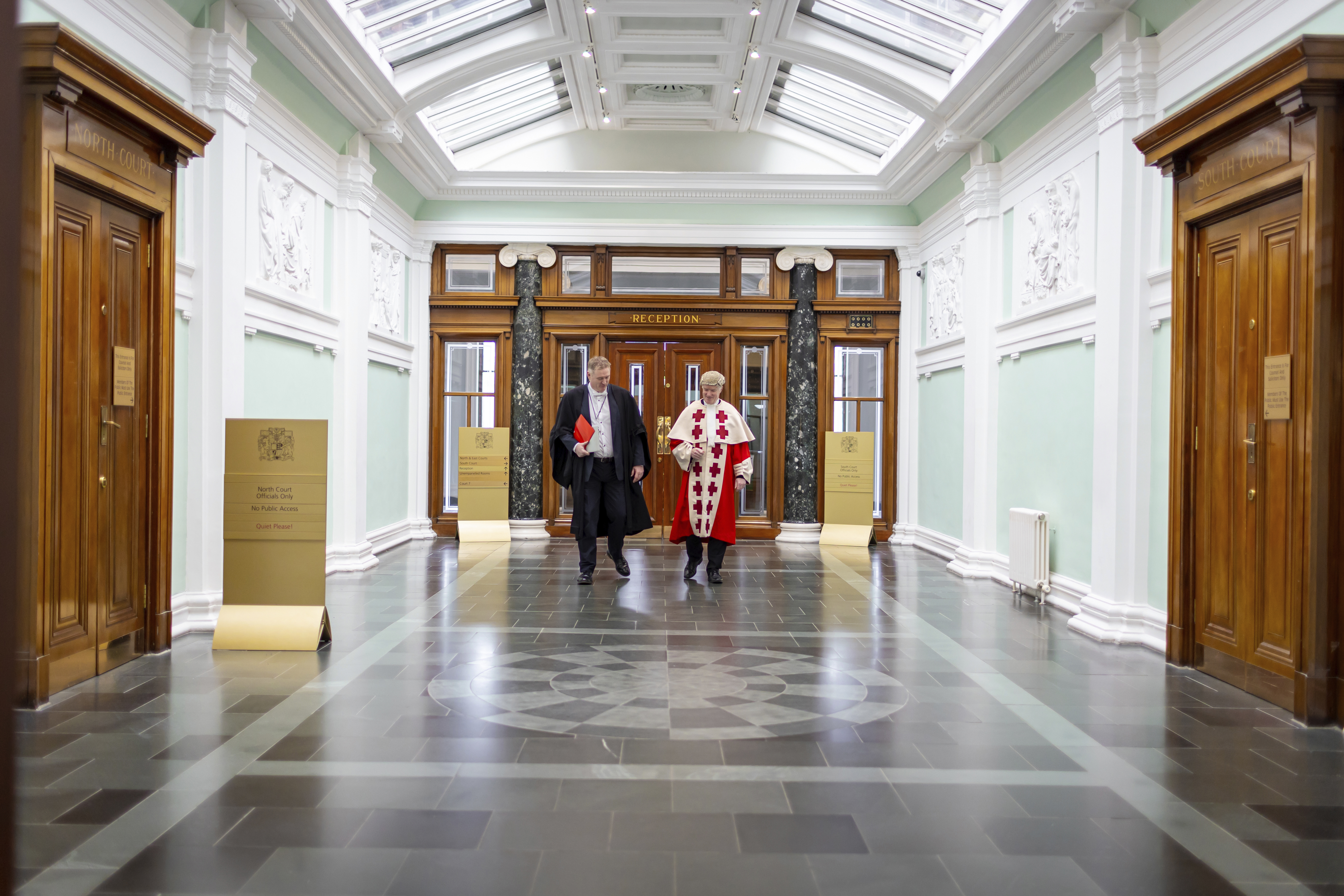 Judge and clerk walking down Glasgow High Court corridor